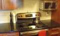 A Kenmore (Electrolux) electric stove in a condo kitchen